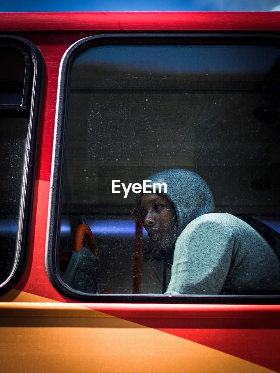 REFLECTION OF MAN IN CAR WINDOW