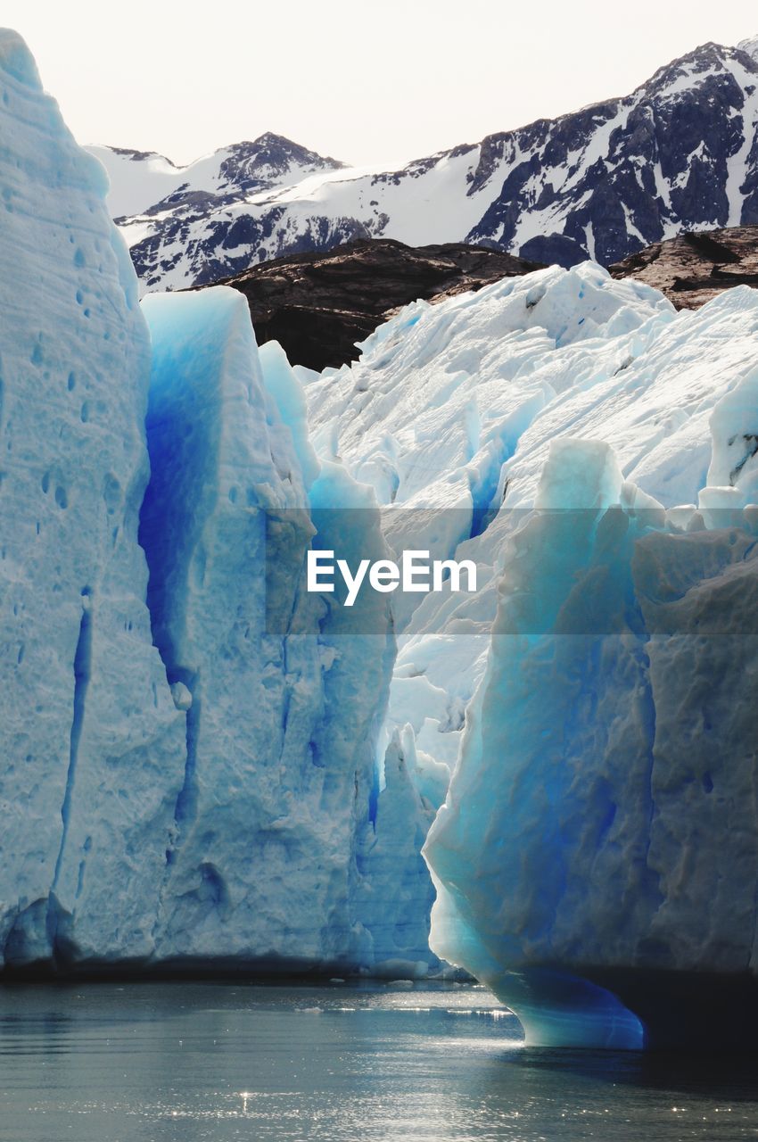 Scenic view of grey glacier against mountain