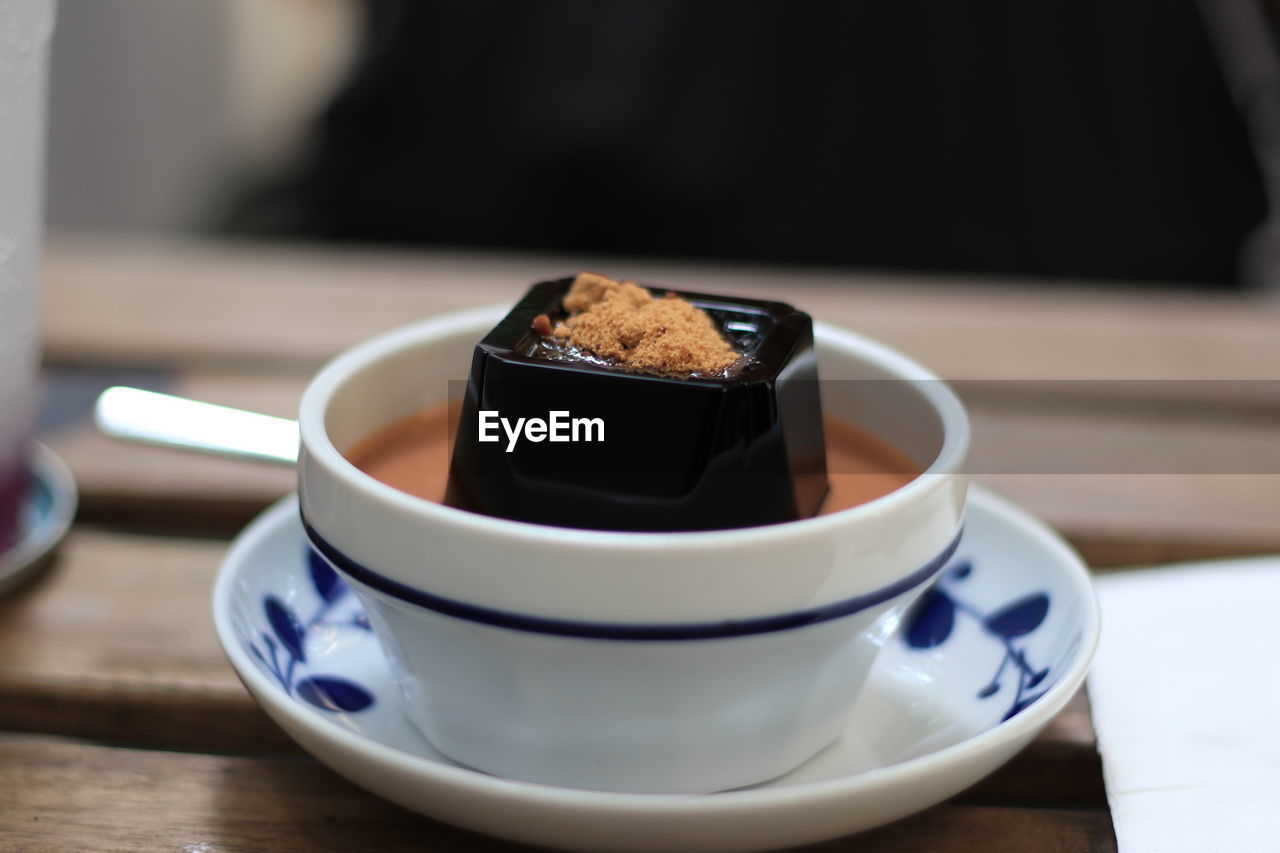 Close-up of black jelly with thai tea on table