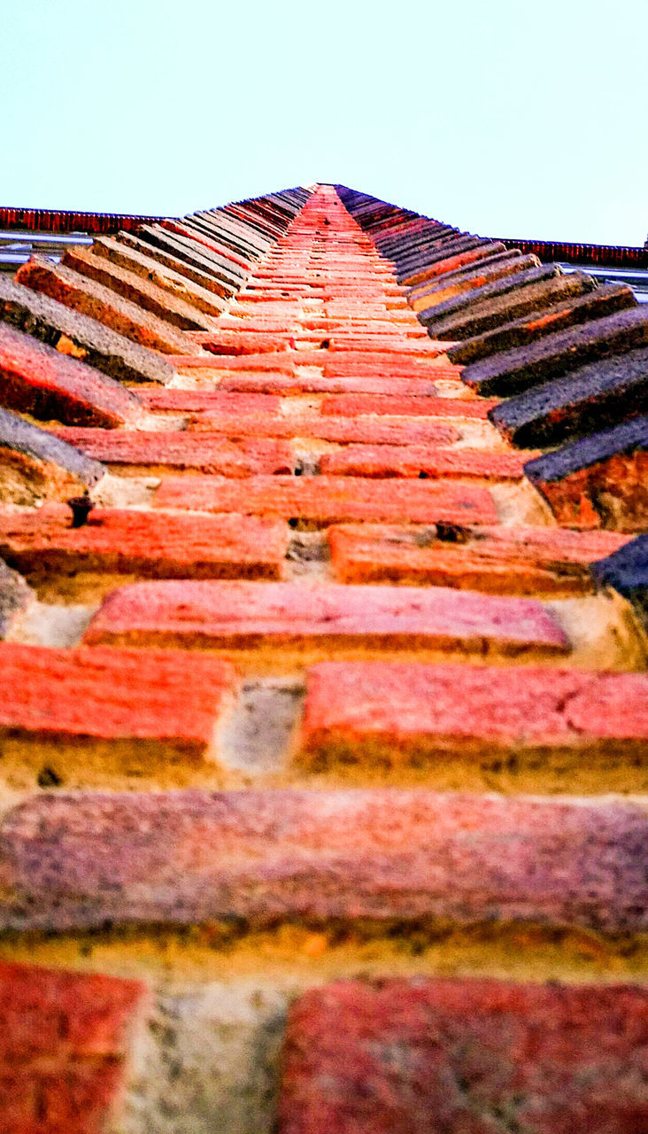 LOW ANGLE VIEW OF BRICK WALL AGAINST SKY