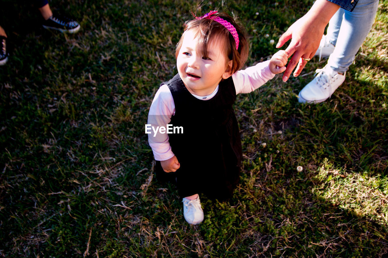 High angle view of girl standing on grass