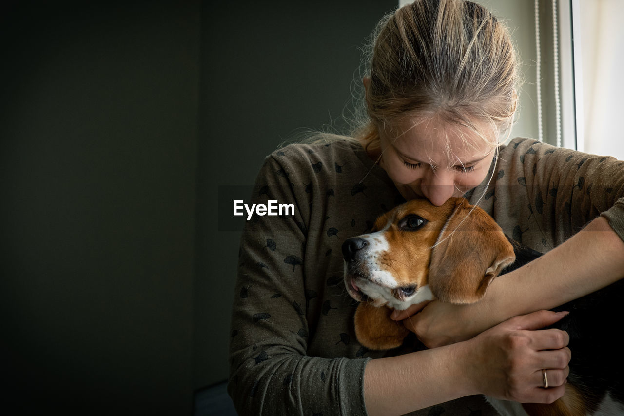 Girl loving and hugging tightly her dog. real feelings. animal protection.