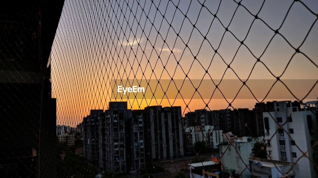 Buildings in city during sunset