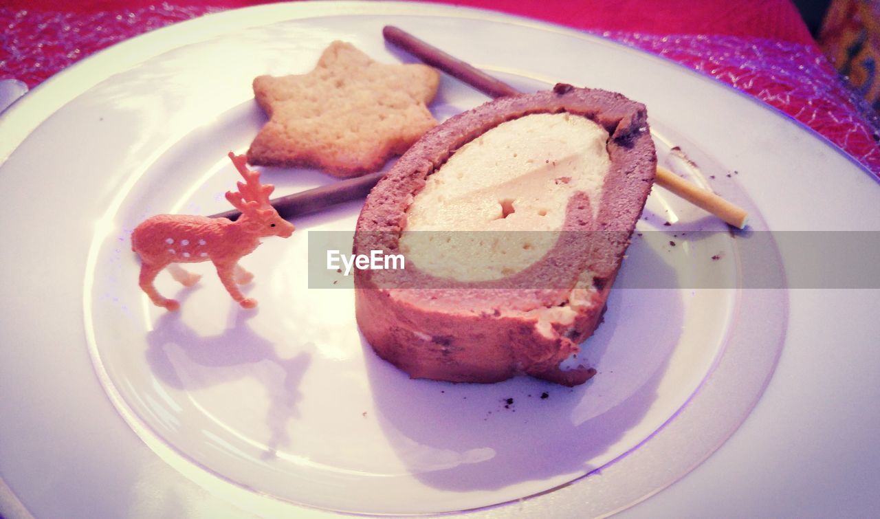 Close-up of cookies and cake on plate during christmas