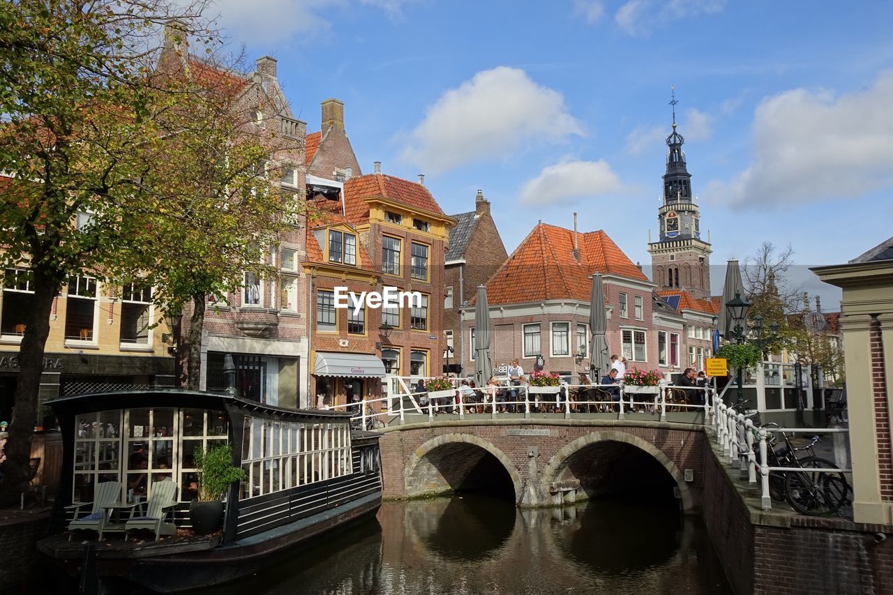 Arch bridge over canal against buildings in city