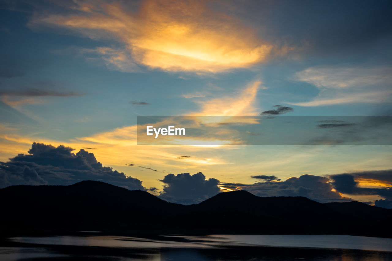 Scenic view of silhouette mountains against sky during sunset
