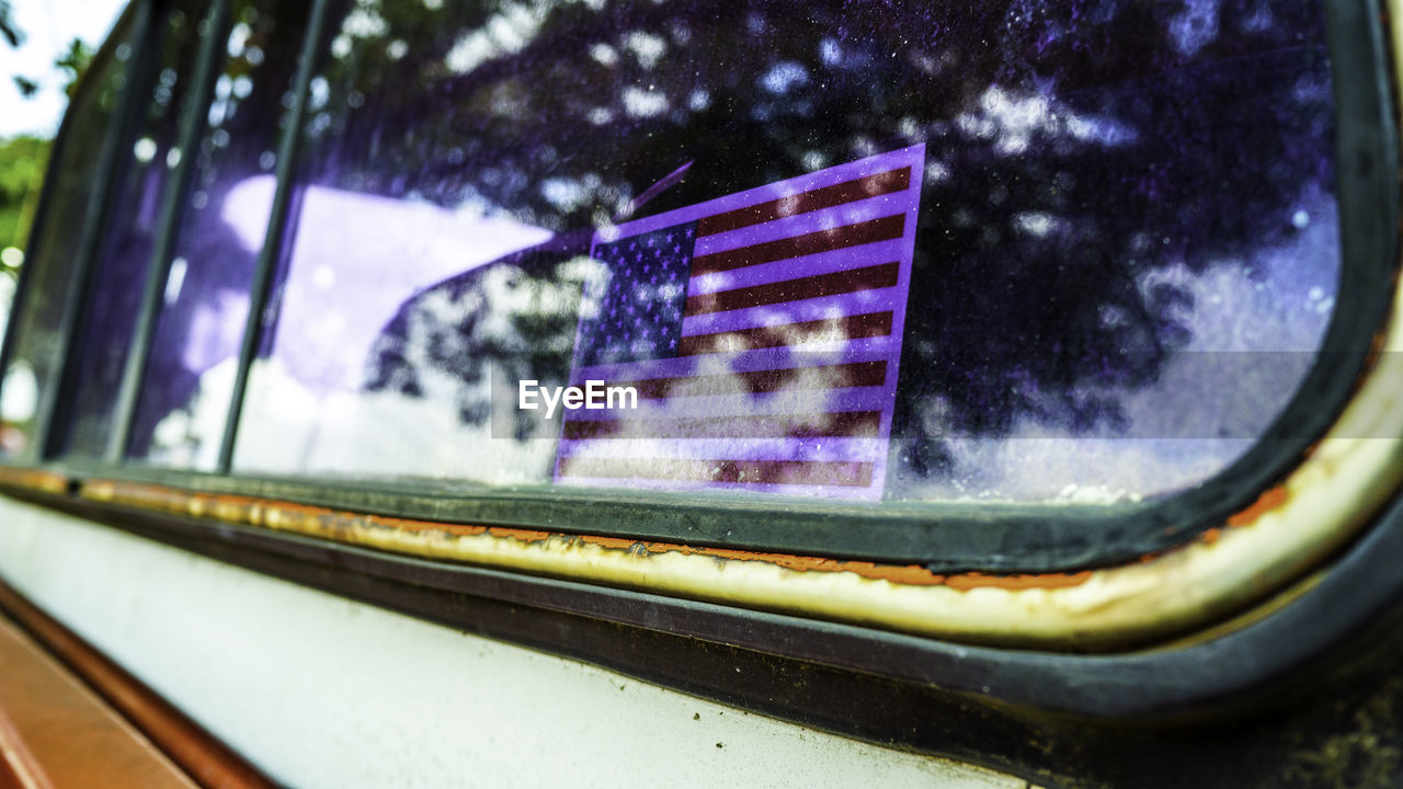 Close-up of american flag on window