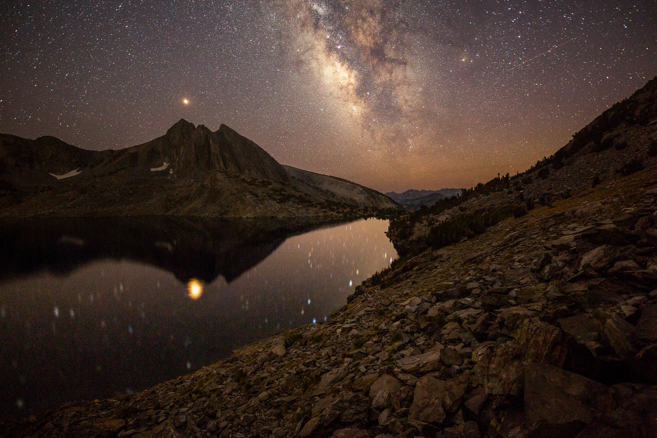 Scenic view of snowcapped mountains against sky at night