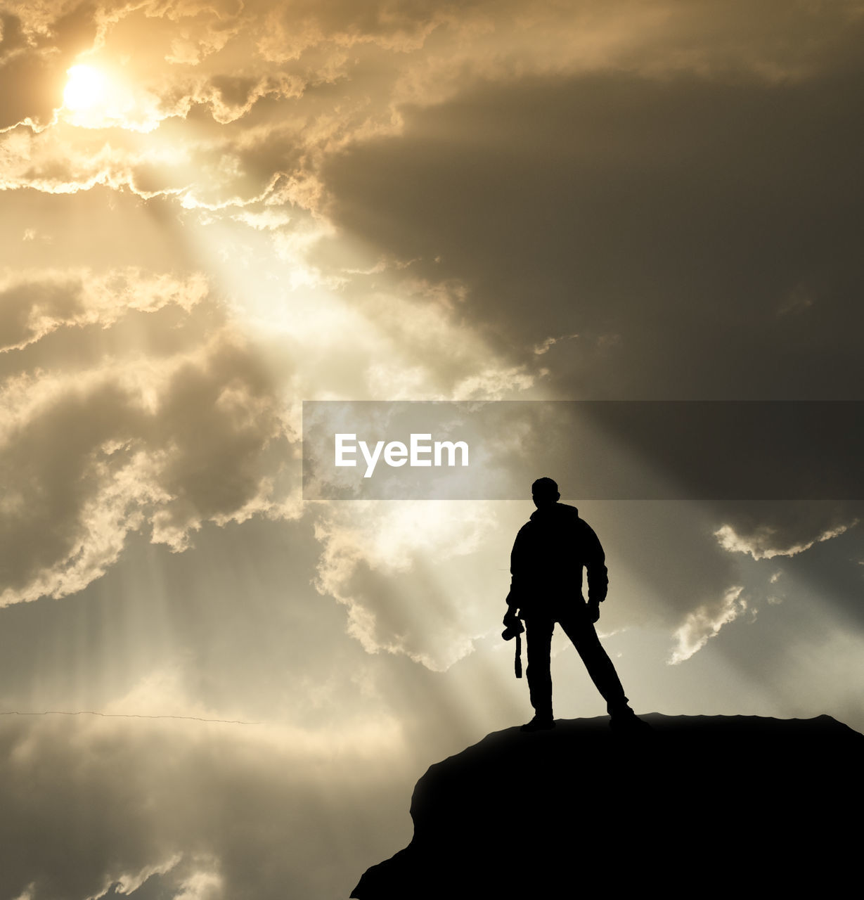 Silhouette of friends against mountain during sunset