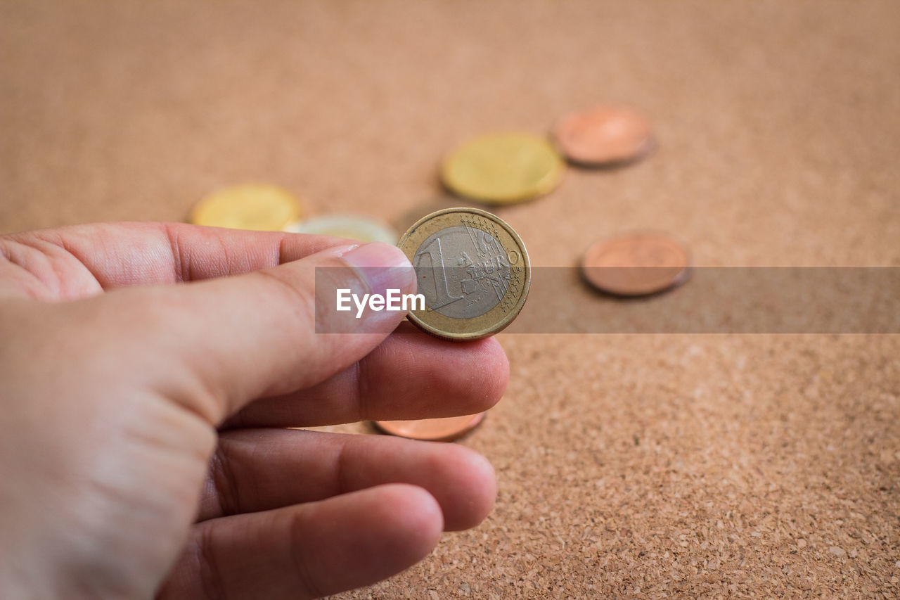 Close-up of hands counting coins on table