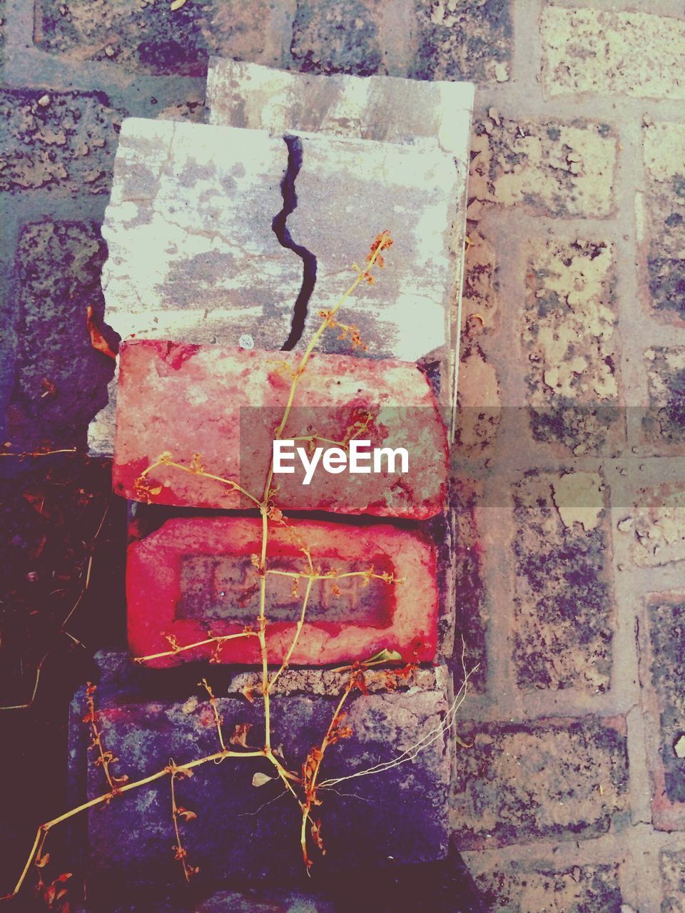 Stack of brick and stone by wall