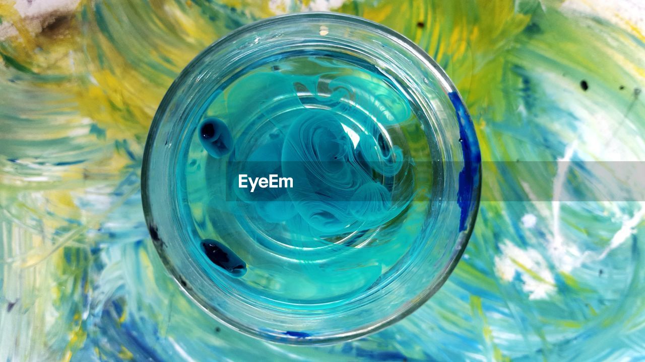 Paint on water in drinking glass