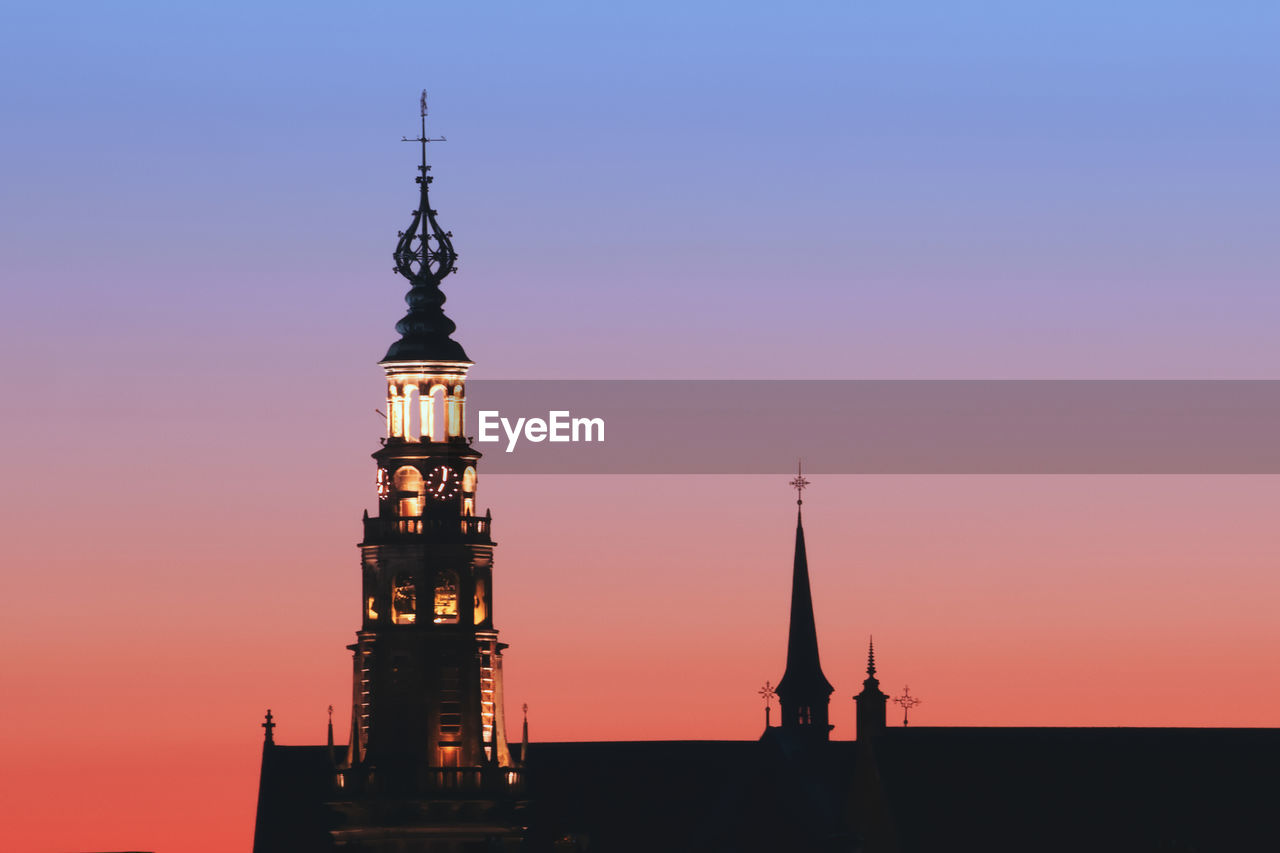 Silhouette of lighthouse against sky during sunset