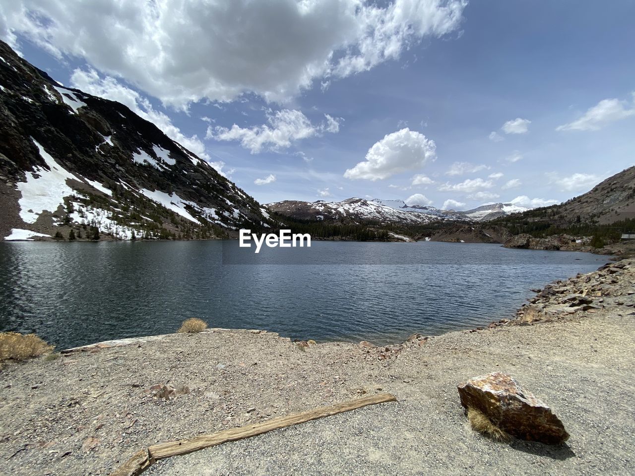 mountain, water, scenics - nature, sky, beauty in nature, lake, cloud, nature, environment, mountain range, landscape, tranquility, tranquil scene, snow, land, wilderness, no people, snowcapped mountain, travel destinations, cold temperature, rock, body of water, travel, day, reservoir, winter, outdoors, beach, non-urban scene, shore, mountain peak, idyllic, reflection, tourism
