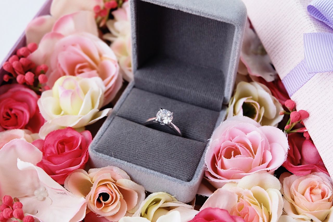 Close-up of wedding ring on roses