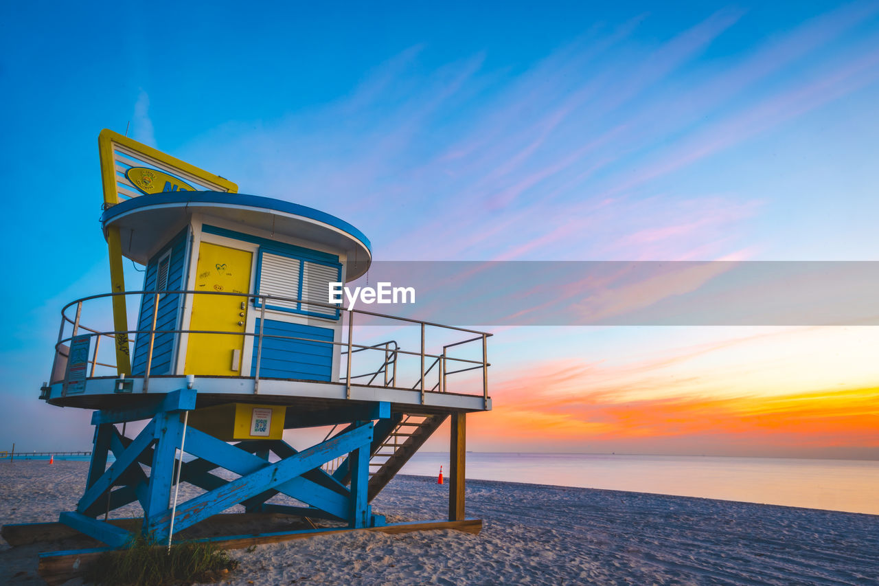 scenic view of beach against sky during sunset