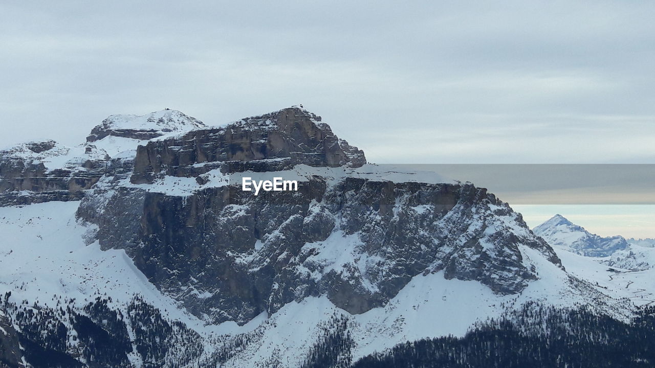 Built structure on snow covered mountain against sky