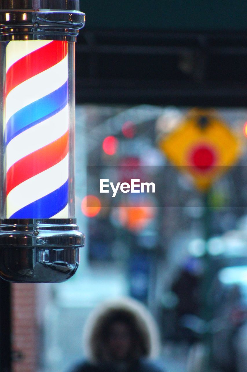 Close-up of multi colored barber shop pole lights on new york city