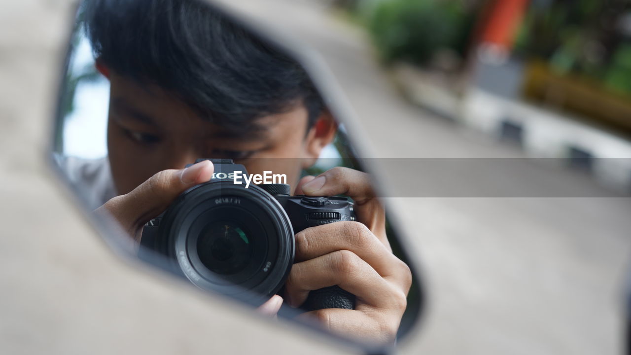 MAN PHOTOGRAPHING CAMERA