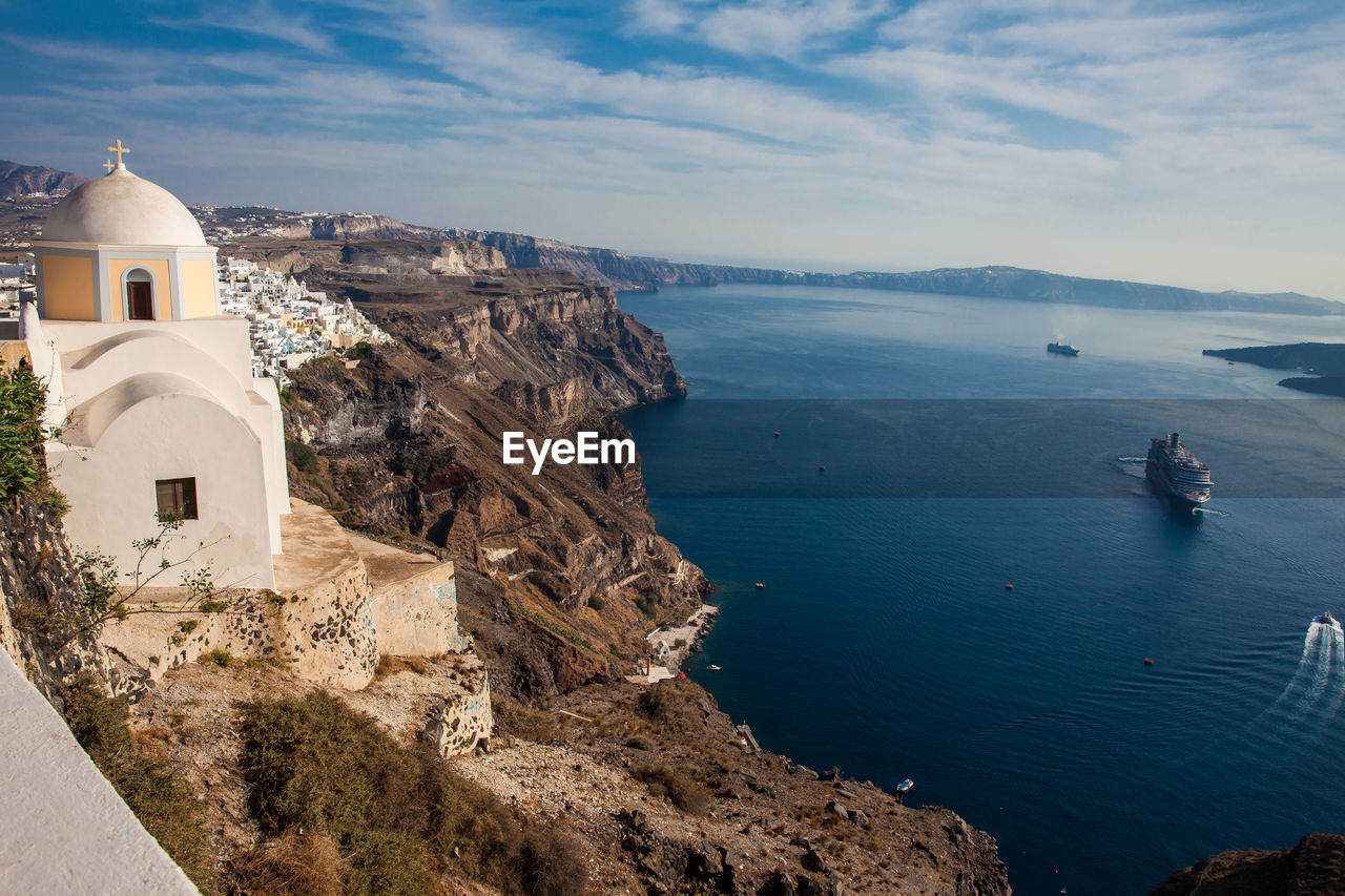 The aegean sea and the catholic church of st. stylianos in the city of fira in santorini island