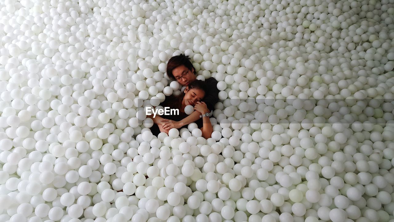 Couple relaxing in pool balls