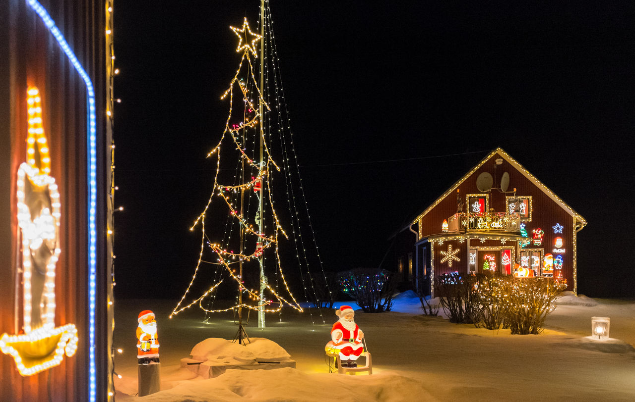 ILLUMINATED CHRISTMAS TREE AT NIGHT DURING FESTIVAL