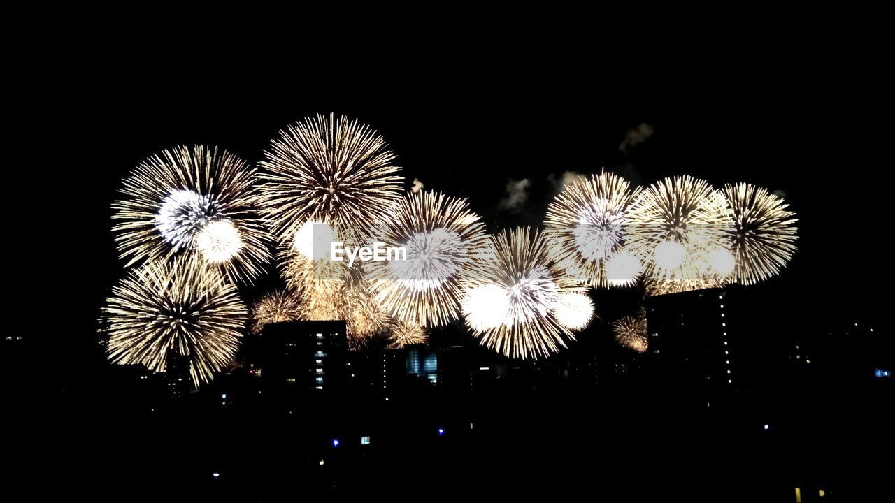 CLOSE-UP OF FIREWORK DISPLAY OVER BLACK BACKGROUND