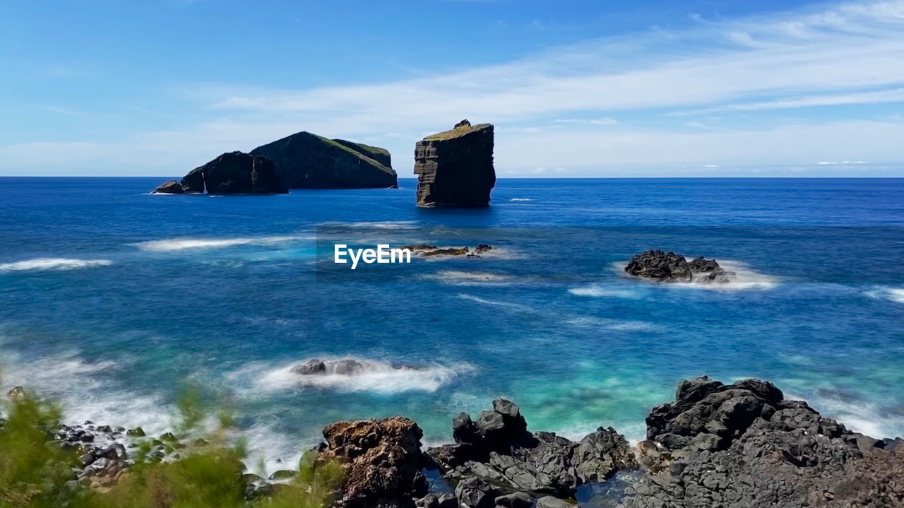 PANORAMIC VIEW OF SEA AND ROCKS AGAINST SKY