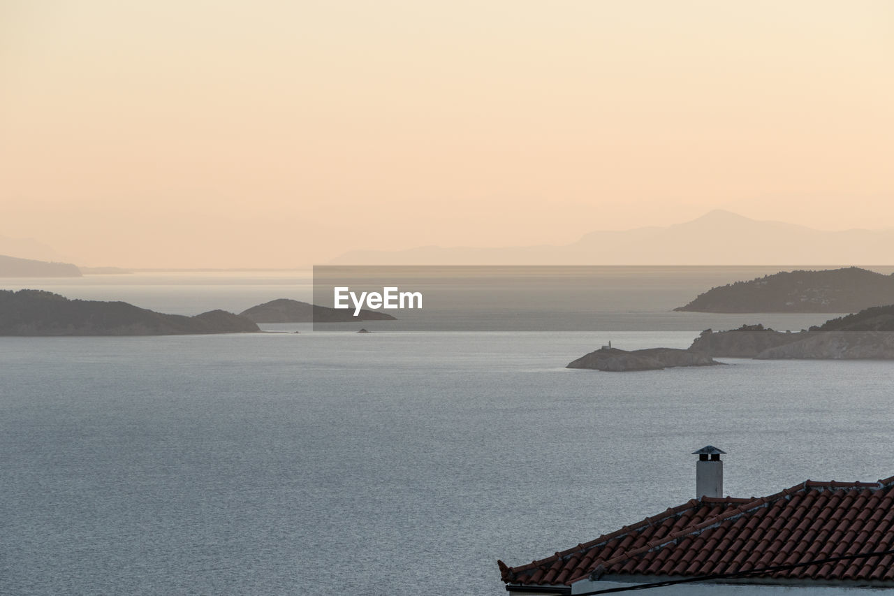 Scenic view of sea against clear sky during sunset