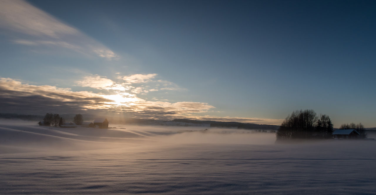 Scenic view of landscape against sky during winter