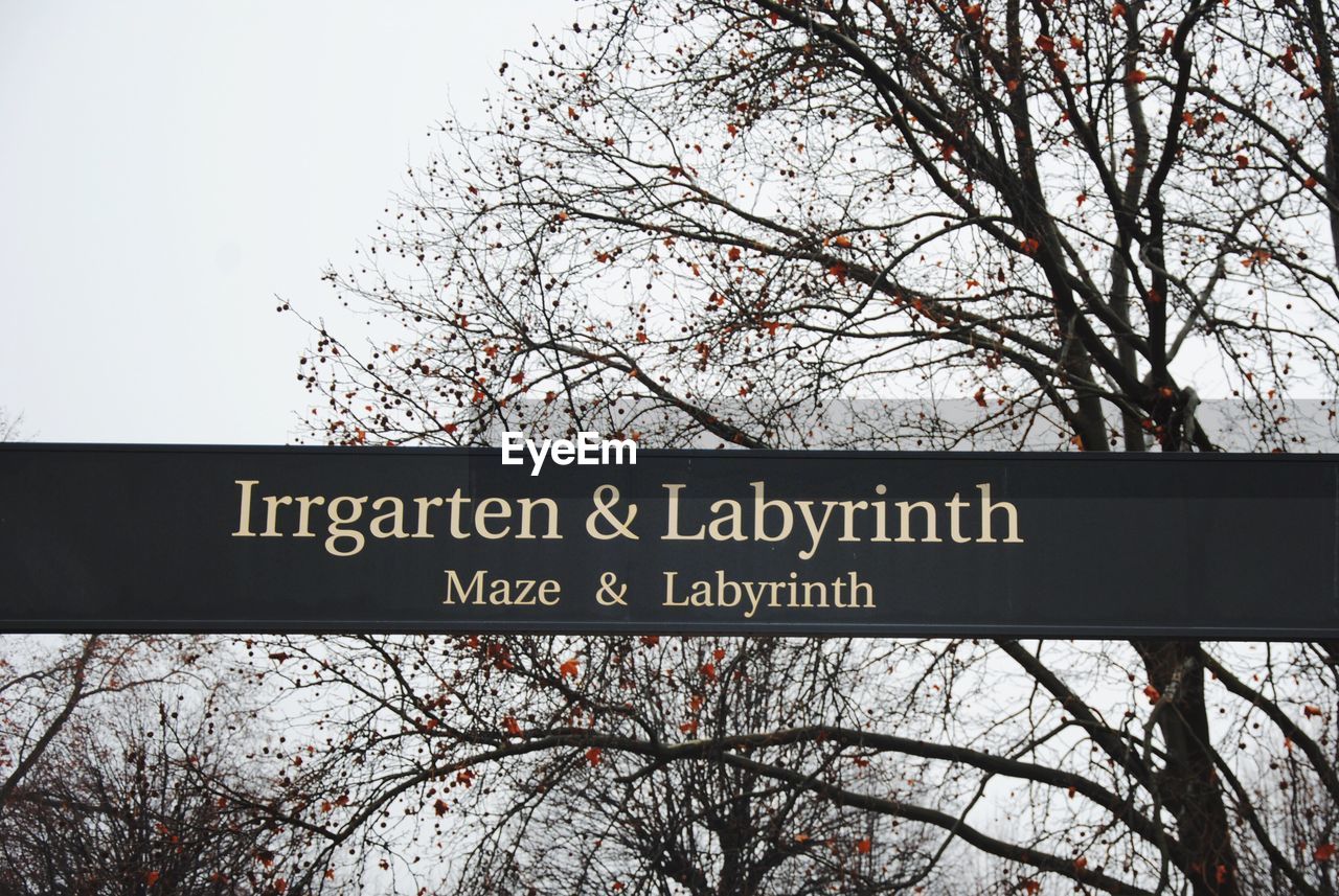 Low angle view of sign board against sky