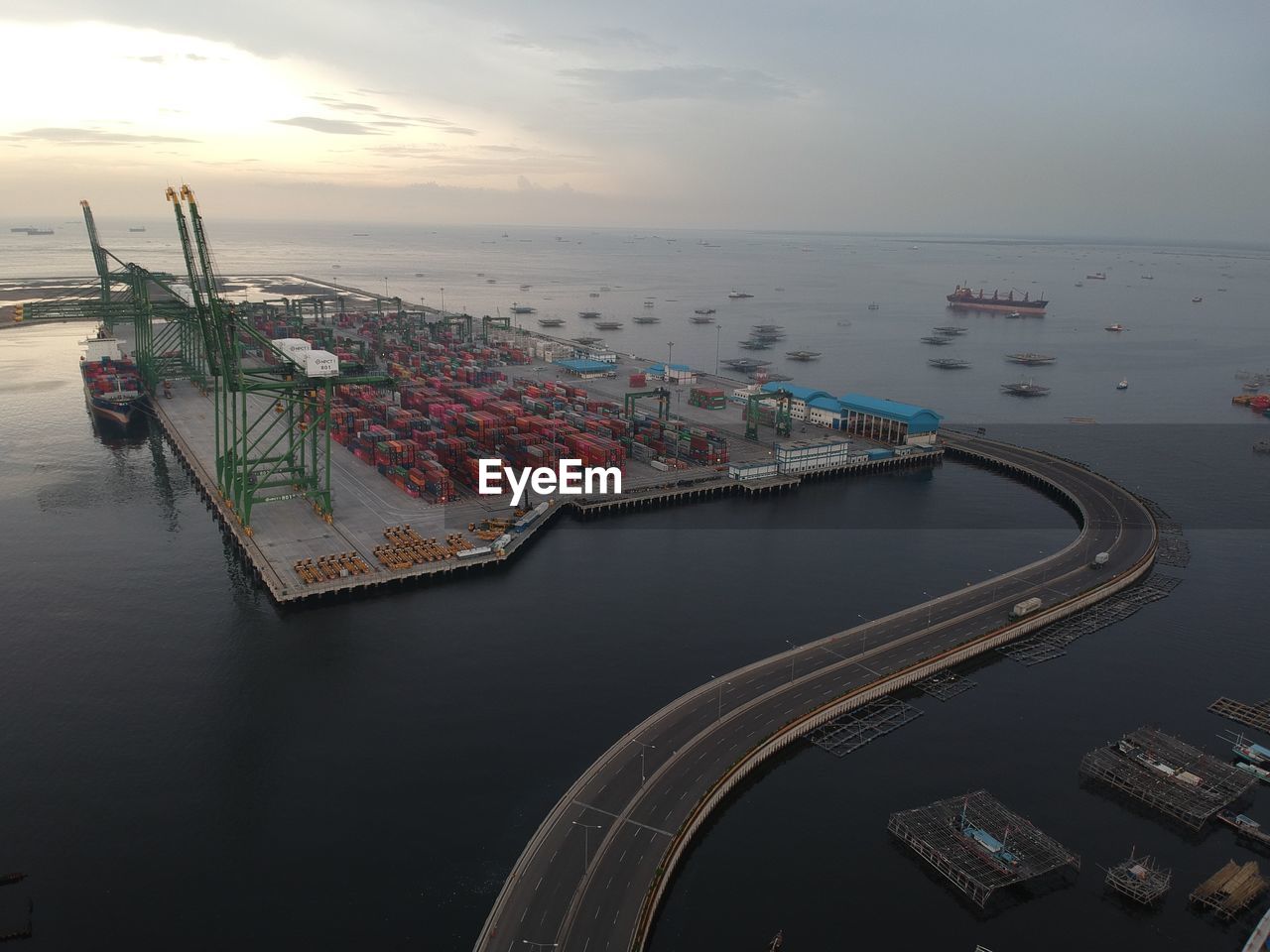 High angle view of commercial dock by sea against sky