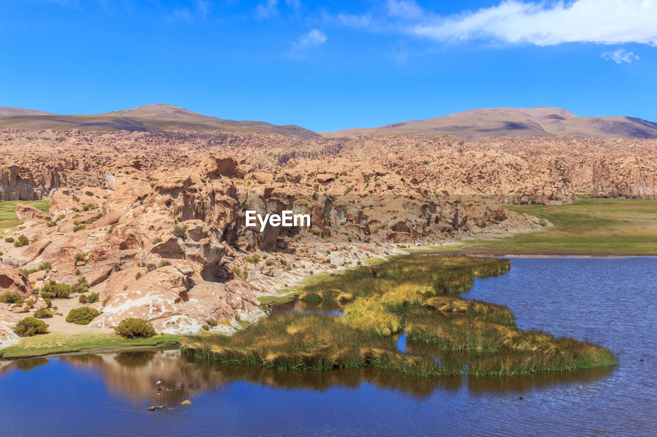 Scenic view of lake and mountains against sky