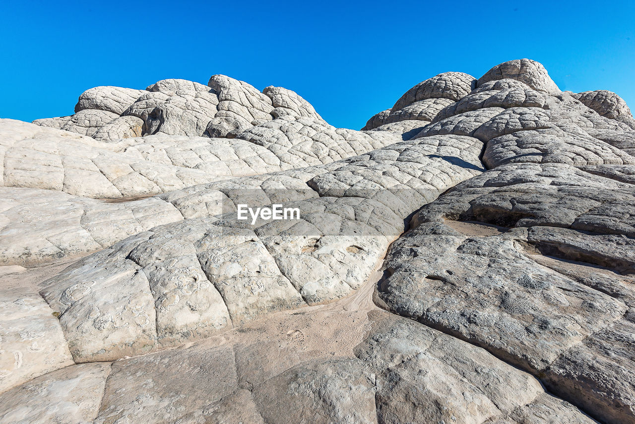 LOW ANGLE VIEW OF ROCK FORMATION AGAINST SKY