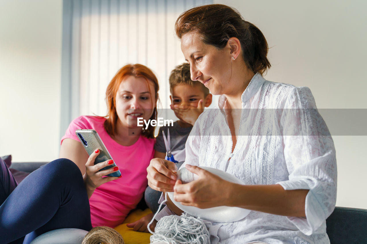 WOMEN SITTING ON SOFA