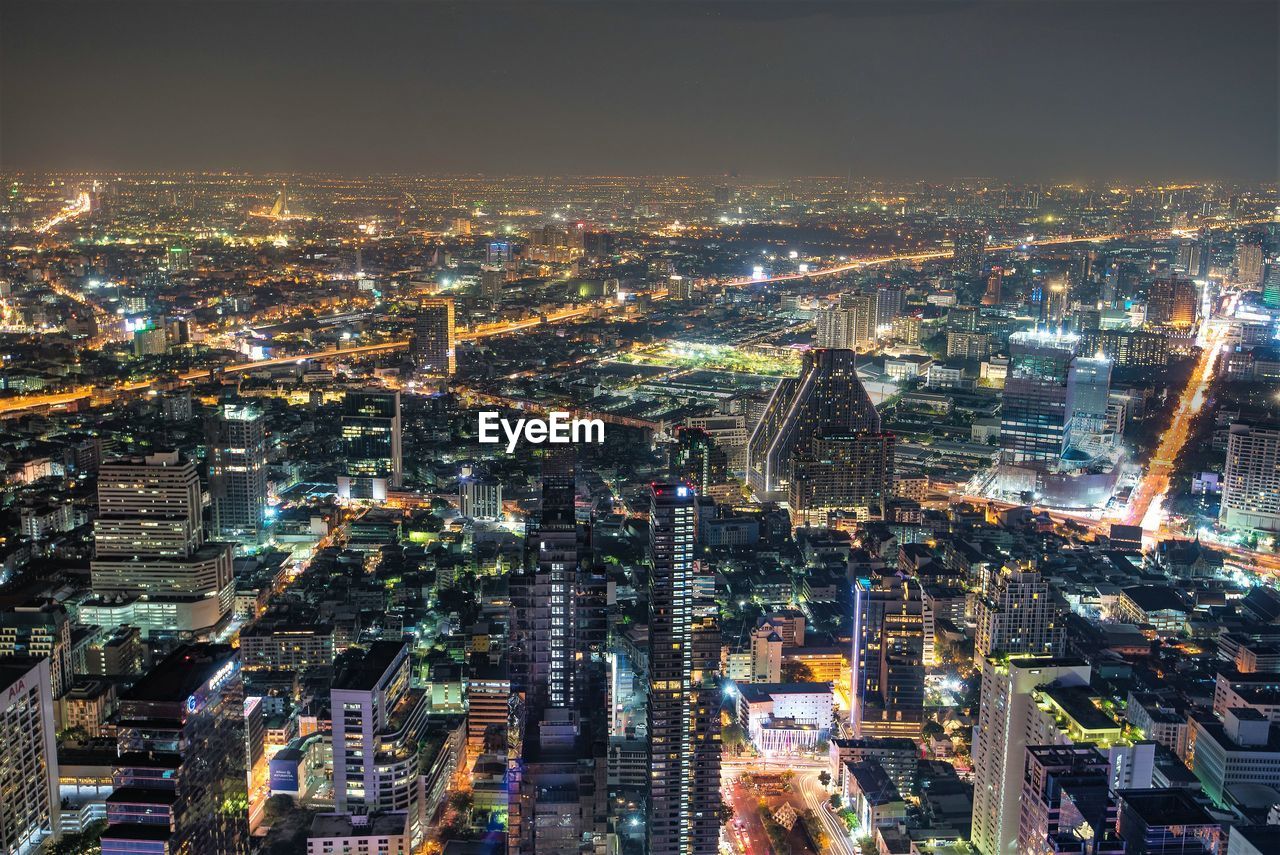 Aerial view of illuminated city buildings at dusk