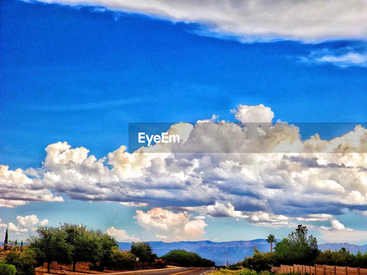 SCENIC VIEW OF MOUNTAINS AGAINST CLOUDY SKY