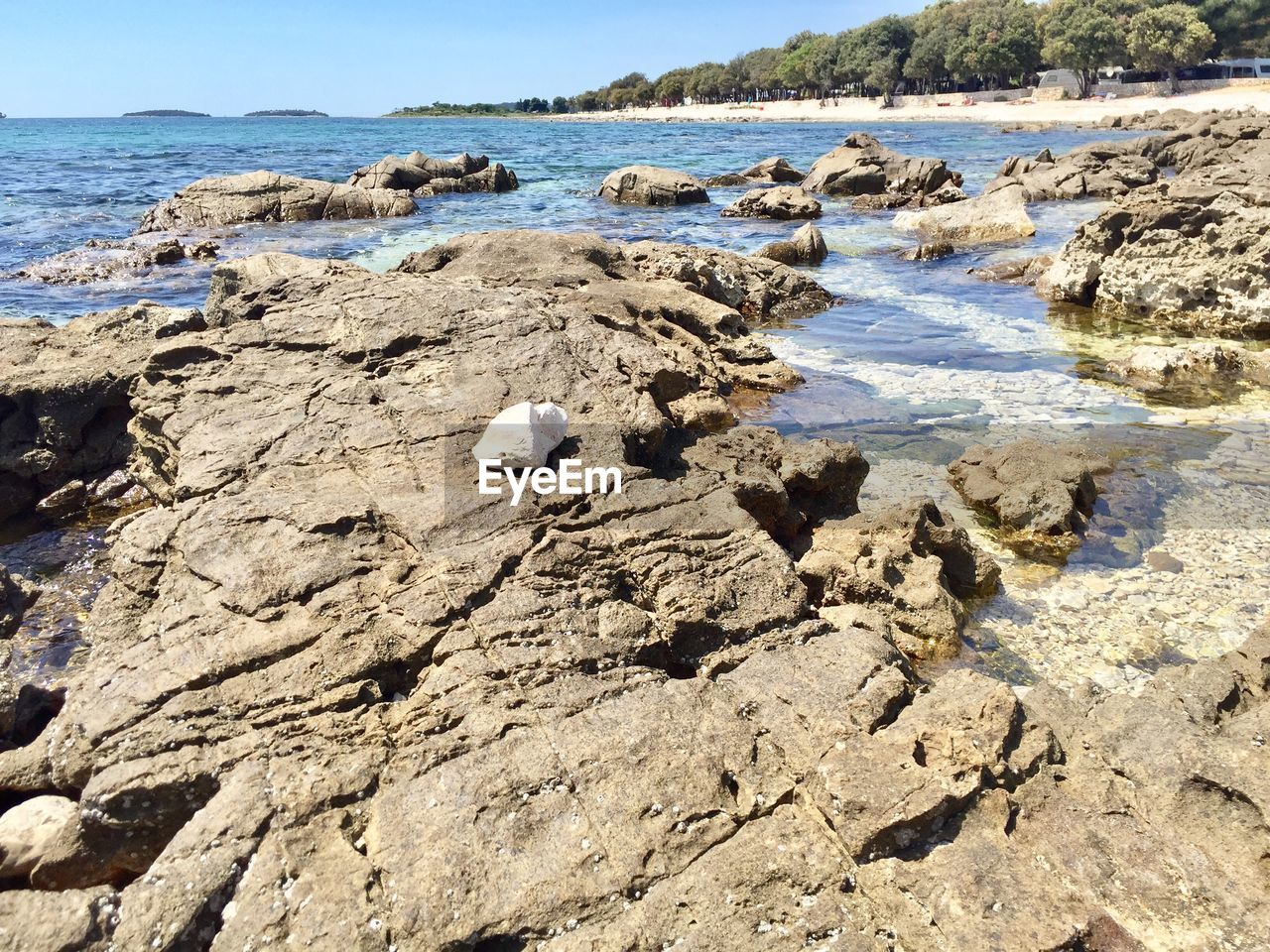 Rocks on beach against sky