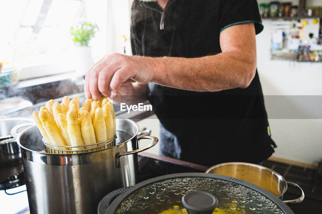 midsection of man preparing food on table