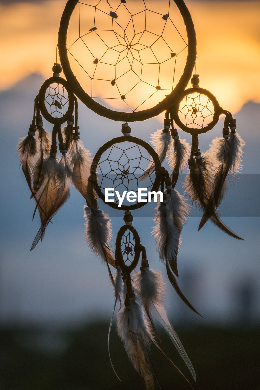 Close-up of dreamcatcher during sunset