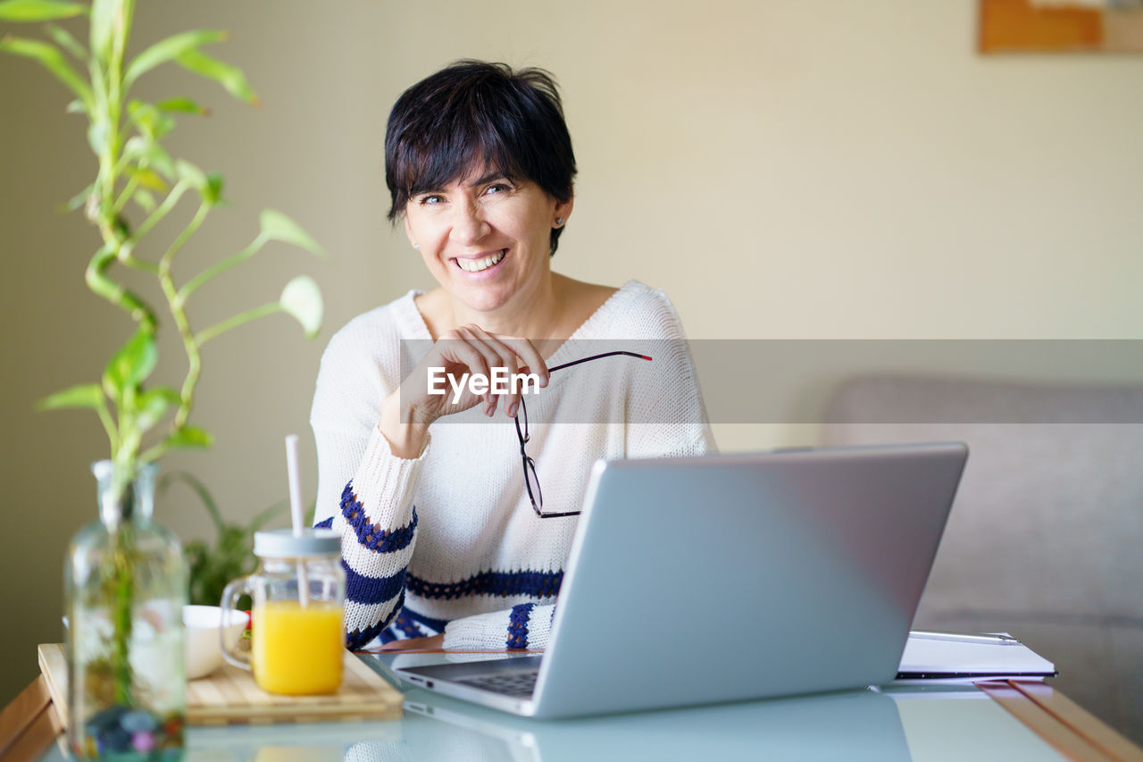 young woman using laptop at table