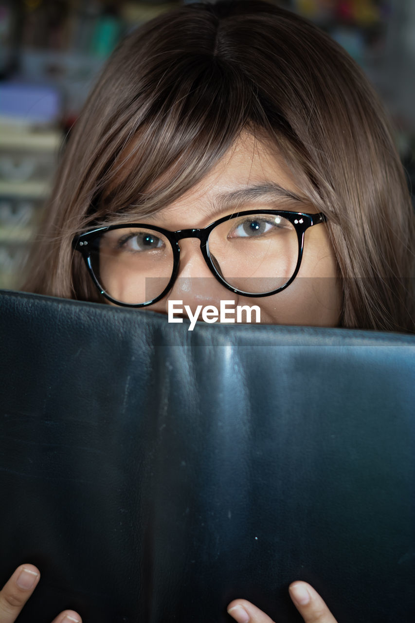 glasses, eyeglasses, vision care, one person, portrait, women, adult, headshot, looking at camera, eyewear, female, human face, young adult, front view, human eye, person, indoors, blue, human hair, close-up, hairstyle, child, education, emotion, black, nose, human head, looking, intelligence, student