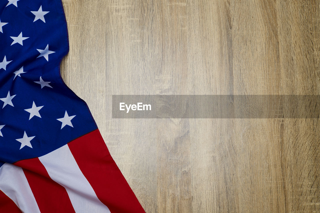 Close-up of american flag on wooden floor