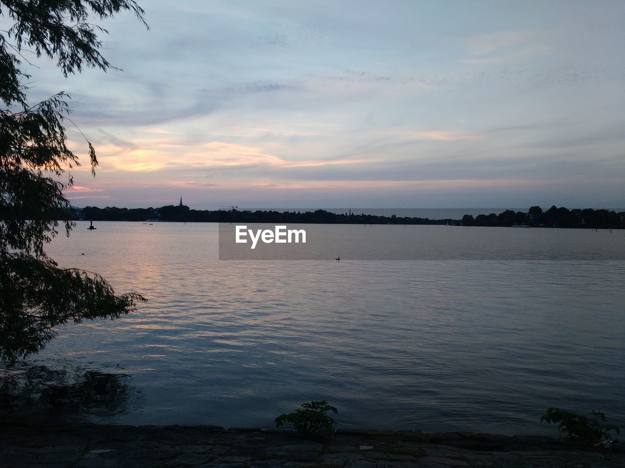 SCENIC VIEW OF BEACH AGAINST SKY DURING SUNSET