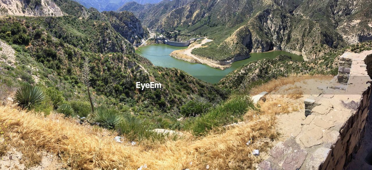 HIGH ANGLE VIEW OF LAKE AGAINST MOUNTAIN