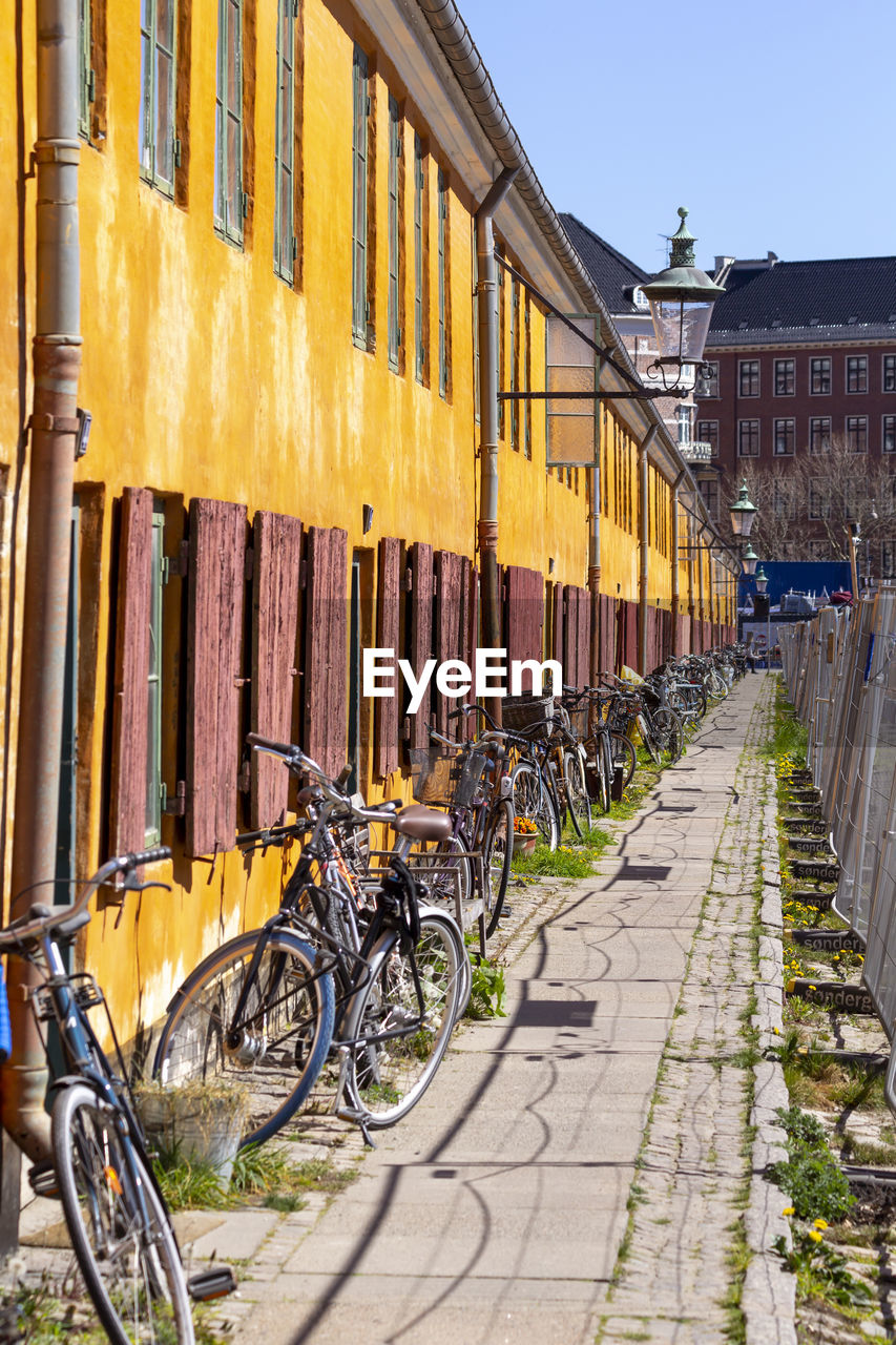 Historic row yellow houses in nyboder neighborhood in copenhagen, a former naval district with bikes 