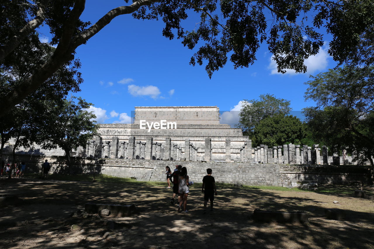 People walking in front of historical building