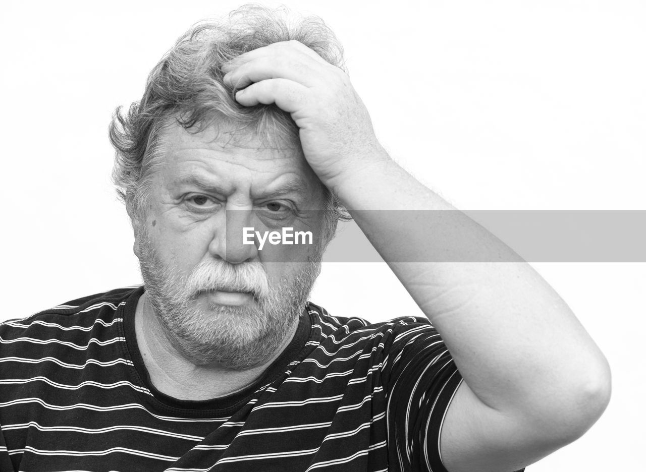 PORTRAIT OF MAN WEARING MASK AGAINST WHITE BACKGROUND
