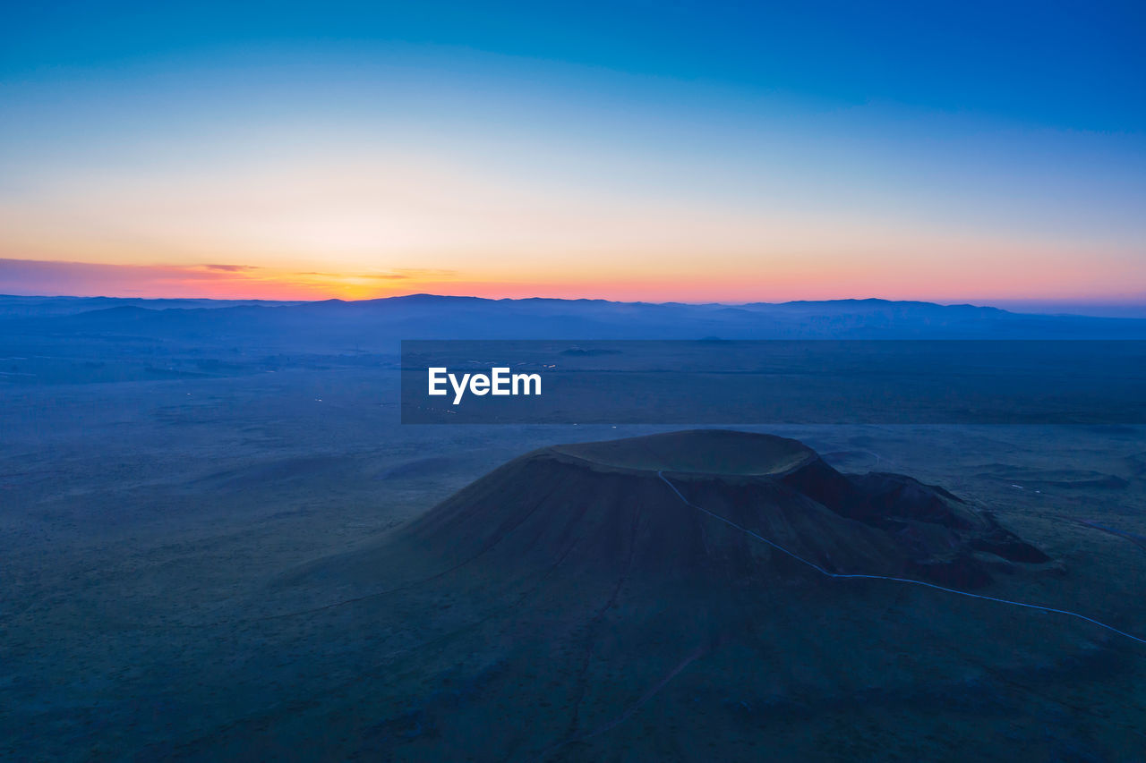 SCENIC VIEW OF SUNSET OVER MOUNTAIN