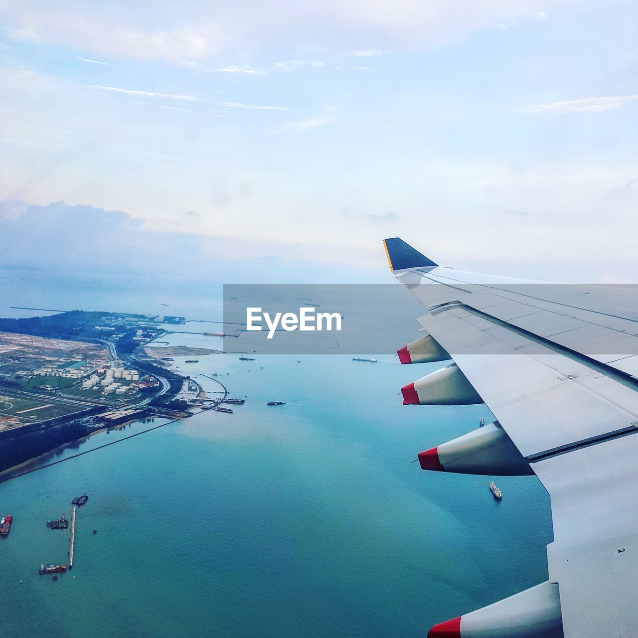 AIRPLANE FLYING ABOVE SEA AGAINST SKY